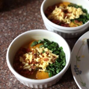 Adding cheese to eggs in ramekin