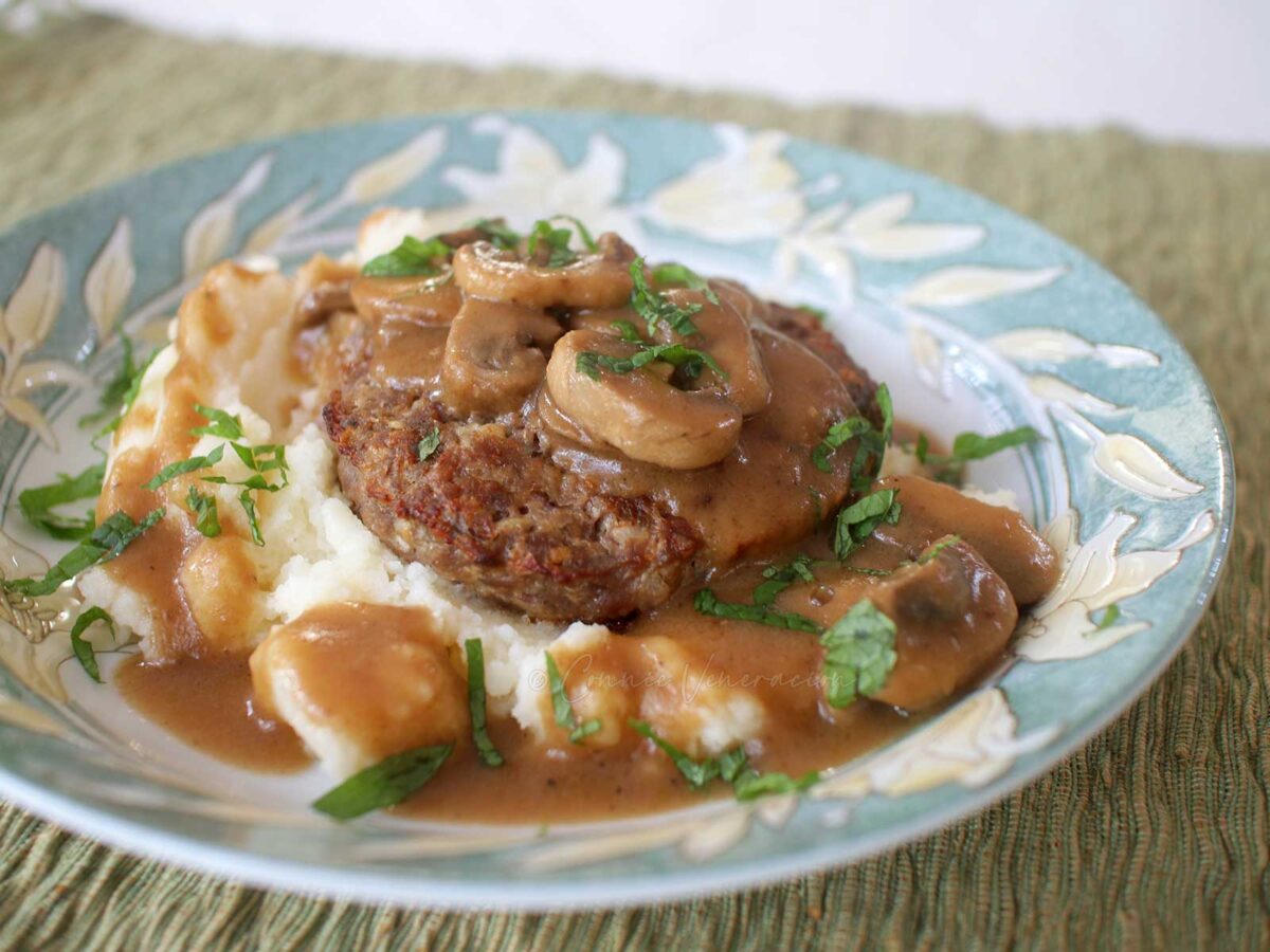 Burger steak and mashed potatoes smothered with fresh mushroom gravy