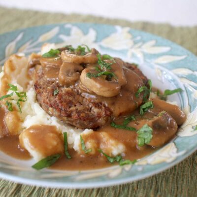 Burger steak and mashed potatoes smothered with fresh mushroom gravy