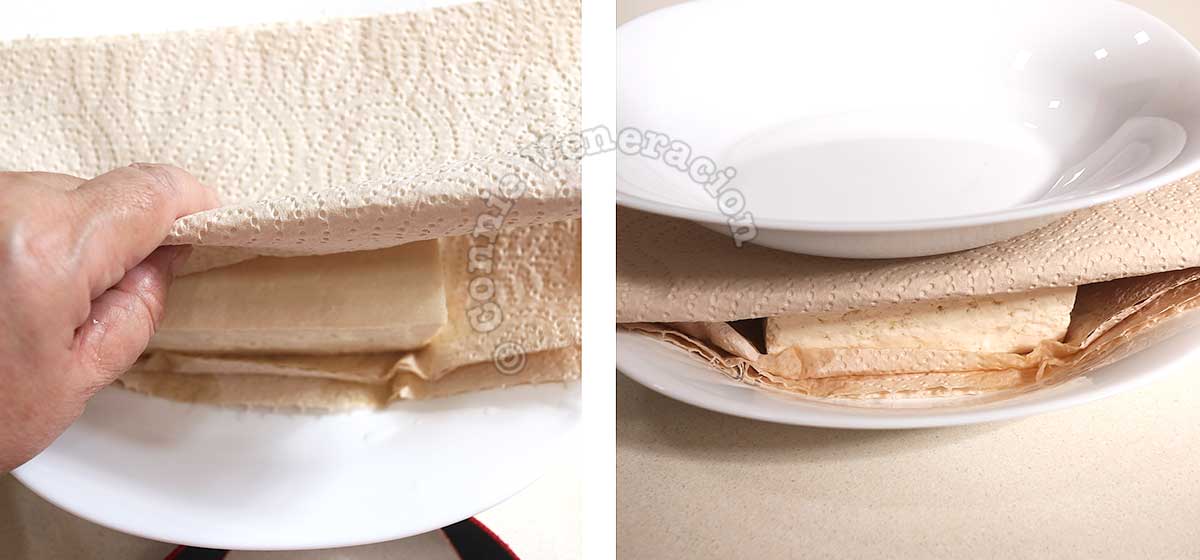 Pressing tofu between stacks of paper towels