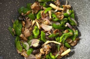 Beef, mushrooms and pepper stir fry in wok