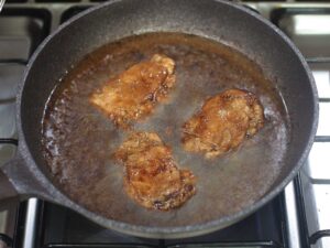 Frying marinated chicken adobo