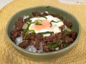 Shakshuka-style ground pork adobo and egg served over rice