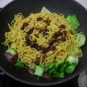 Sauce over stir fried noodles, Chinese sausage and bok choy