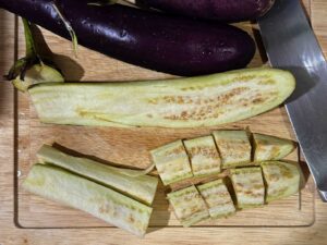 Cutting eggplants into cubes
