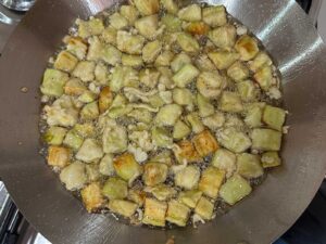 Deep frying battered eggplant cubes