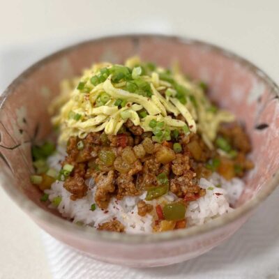 Sweet sour ground pork stew with tomatoes, chilies and sultanas