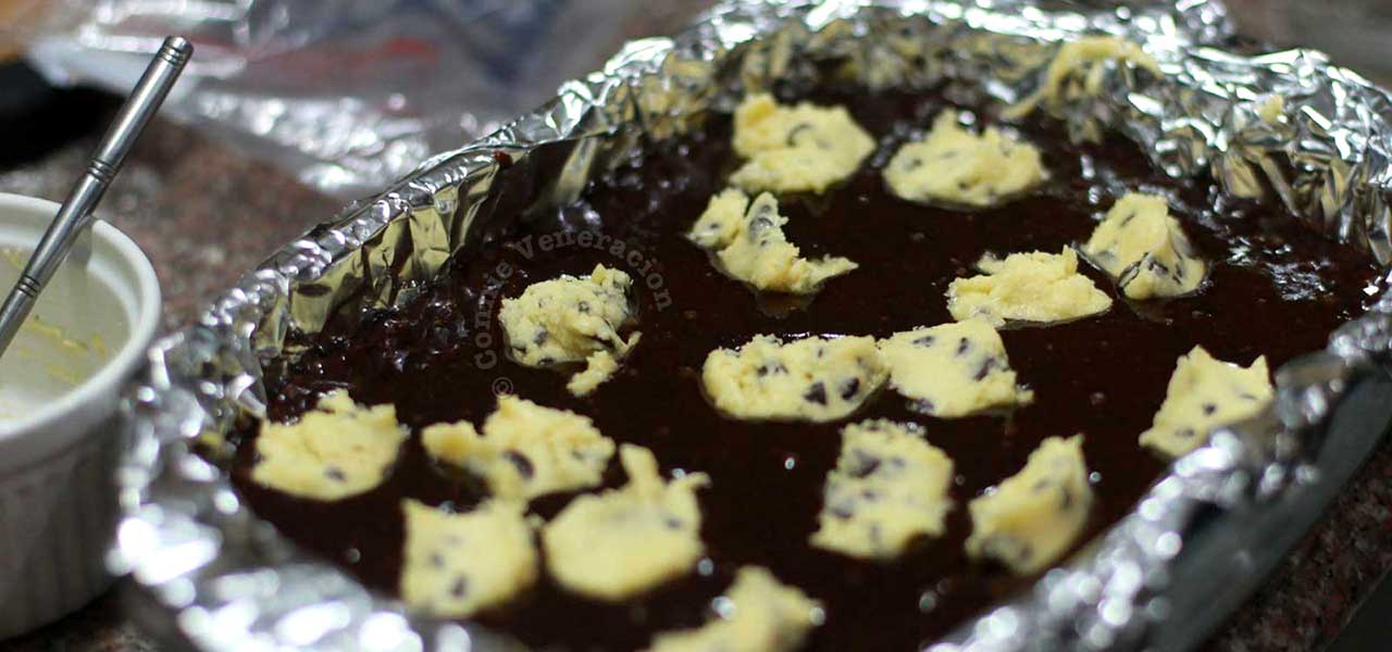 Topping brownie mix with pinches of chocolate chip cookie dough