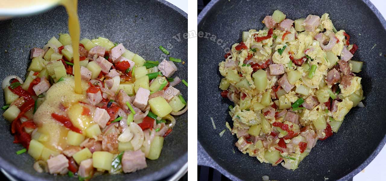 Pouring in beaten eggs over ham, potatoes, onions and bell peppers to make Bauernfrühstück (Farmer’s Breakfast)