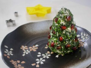 Herb-crusted cream cheese spread dotted with pomegranate seeds