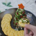 Herb-crusted cream cheese spread dotted with pomegranate seeds