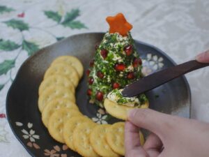 Herb-crusted cream cheese spread dotted with pomegranate seeds