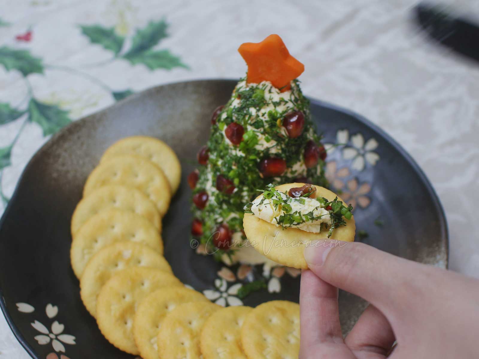 Herb-crusted cream cheese spread dotted with pomegranate seeds