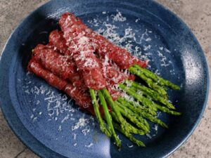 Grilled salami-wrapped asparagus