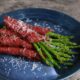 Grilled salami-wrapped asparagus
