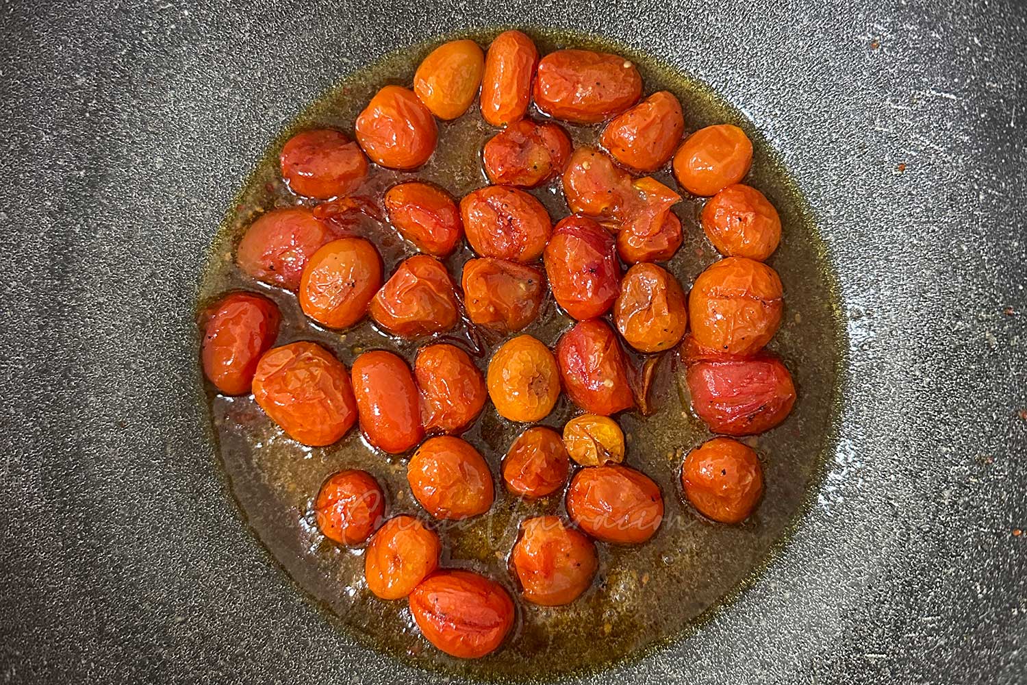 Simmering roasted tomatoes in boney butter sauce
