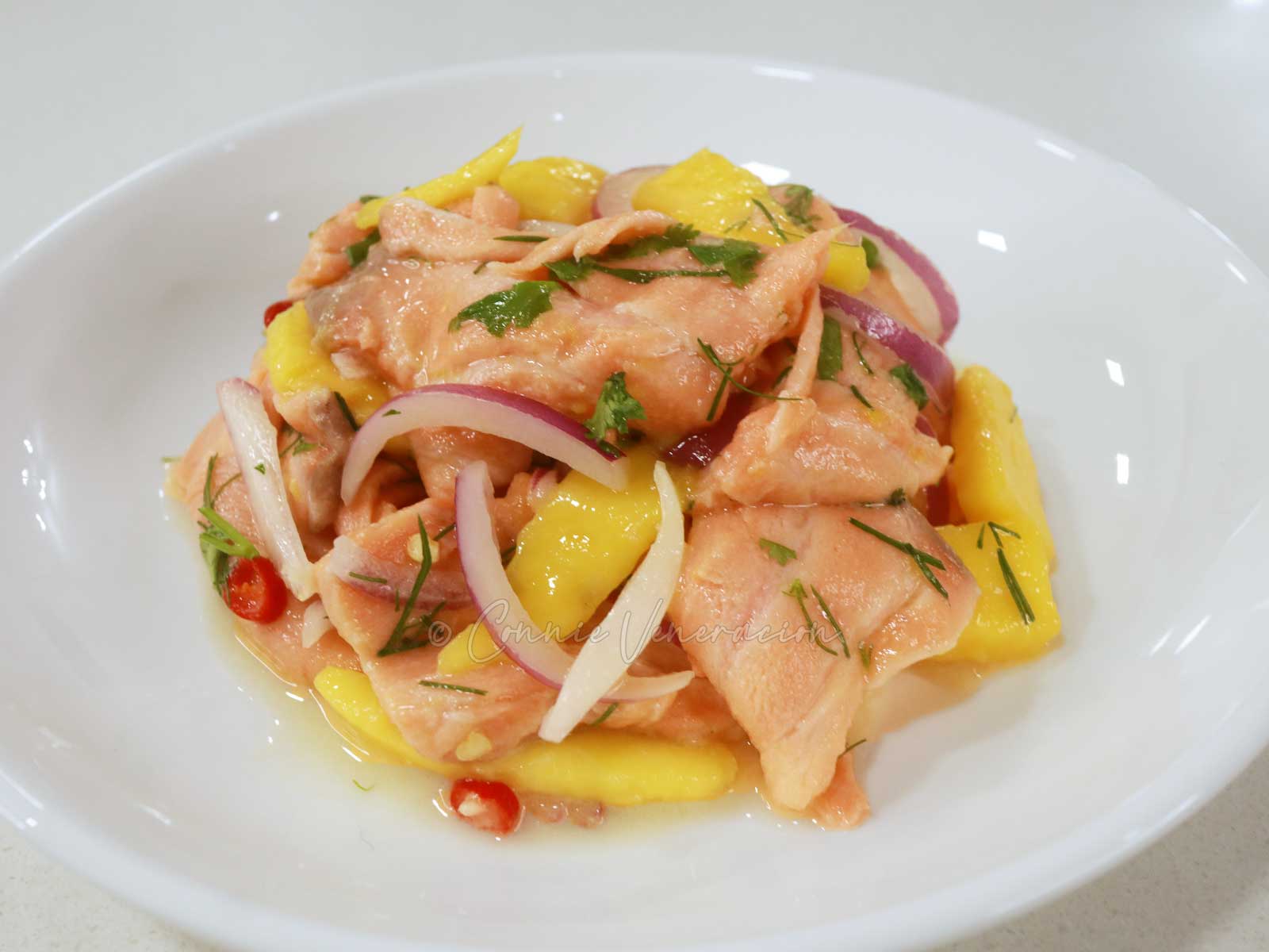 Salmon ceviche with dill, cilantro, red onion, chilies and fresh sweet mango