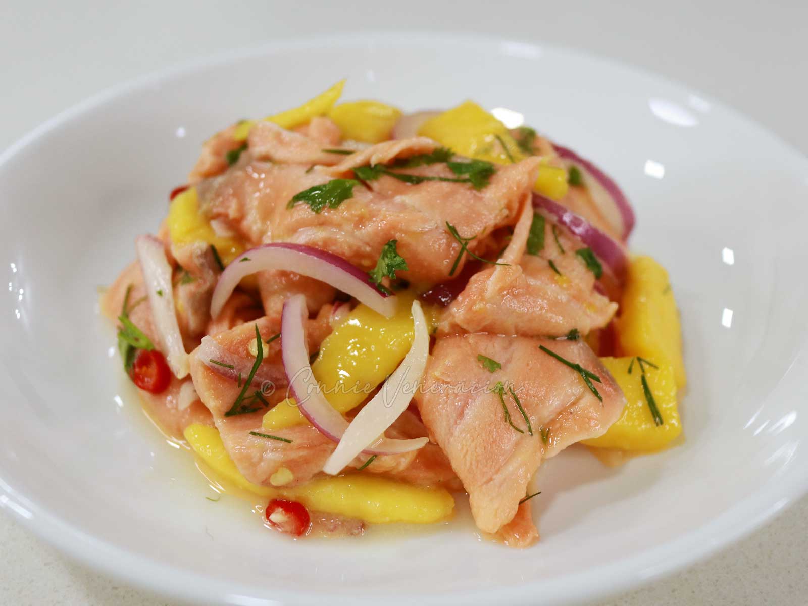 Salmon ceviche with dill, cilantro, red onion, chilies and fresh sweet mango