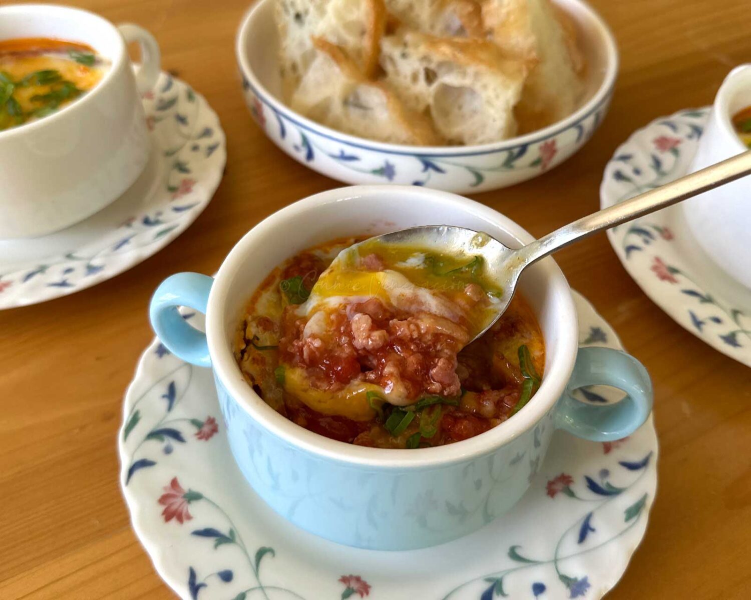 Eggs en cocotte with bacon and sausage meat ragu