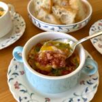 Eggs en cocotte with bacon and sausage meat ragu