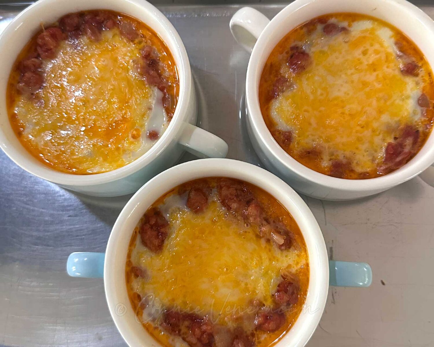 Eggs en cocotte topped with cheese