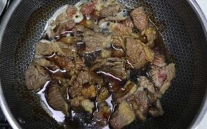 Simmering beef in soy sauce, sake and mirin