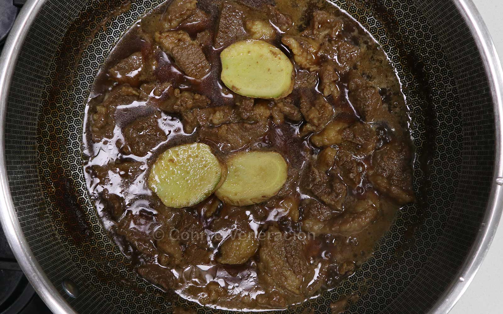 Simmering beef in soy sauce, sake, mirin, sugar and ginger