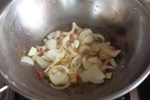 Sauteeing onion, garlic, ginger, lemongrass and chilies