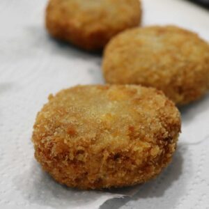 Draining fried crab cakes on paper towels
