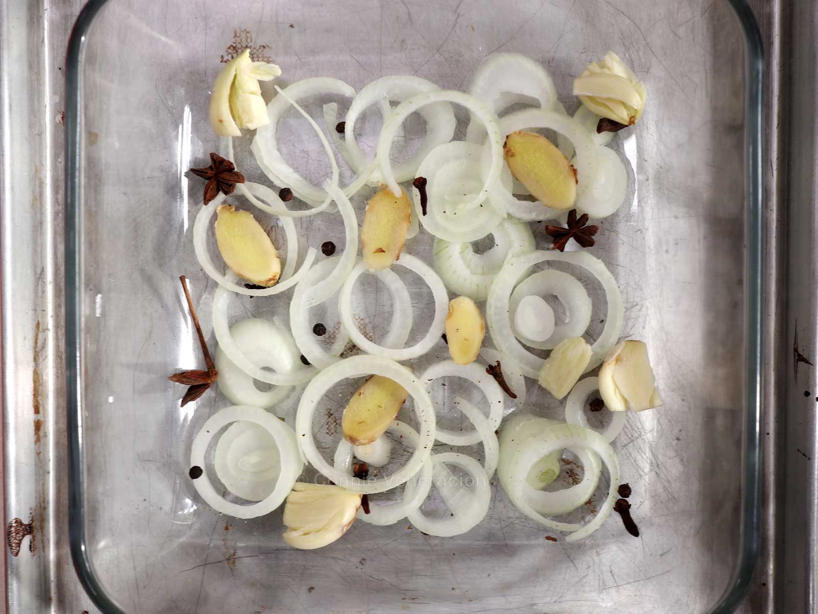 Baking pan lines with spices and onion slices