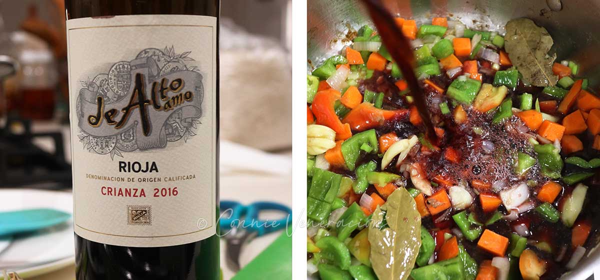 Adding rioja to vegetables in pan