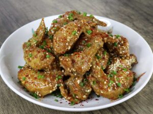 Fried chicken wings glazed with satay sauce