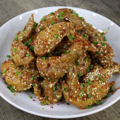 Fried chicken wings glazed with satay sauce