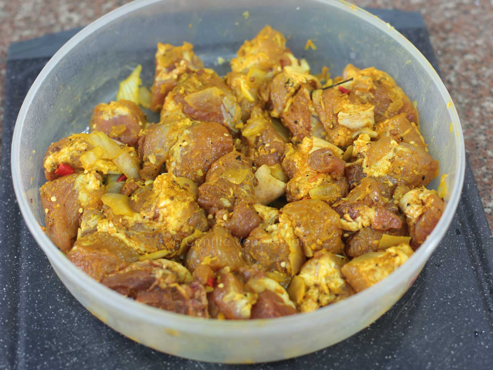 Marinating pork in spices and herbs