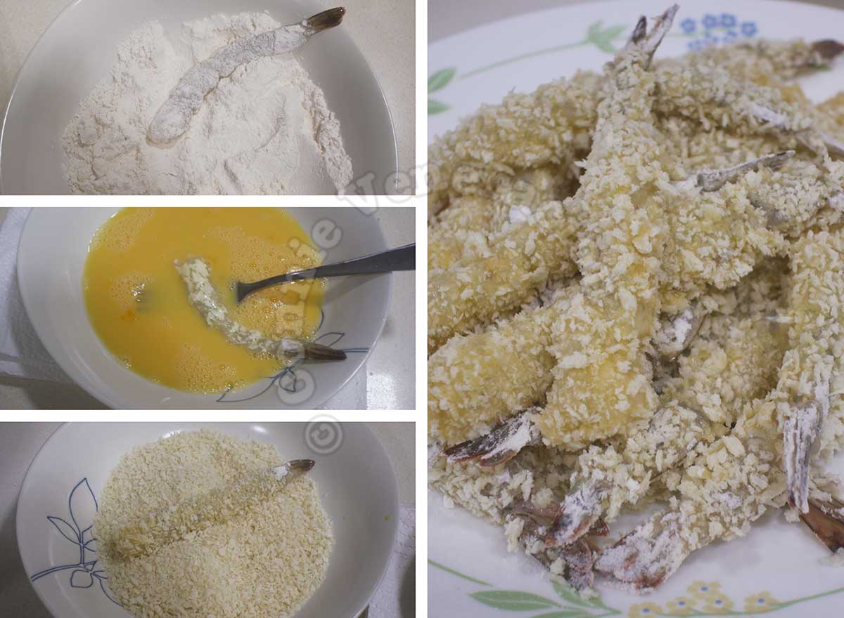Dredging shimps in flour, dipping in egg and coating with panko