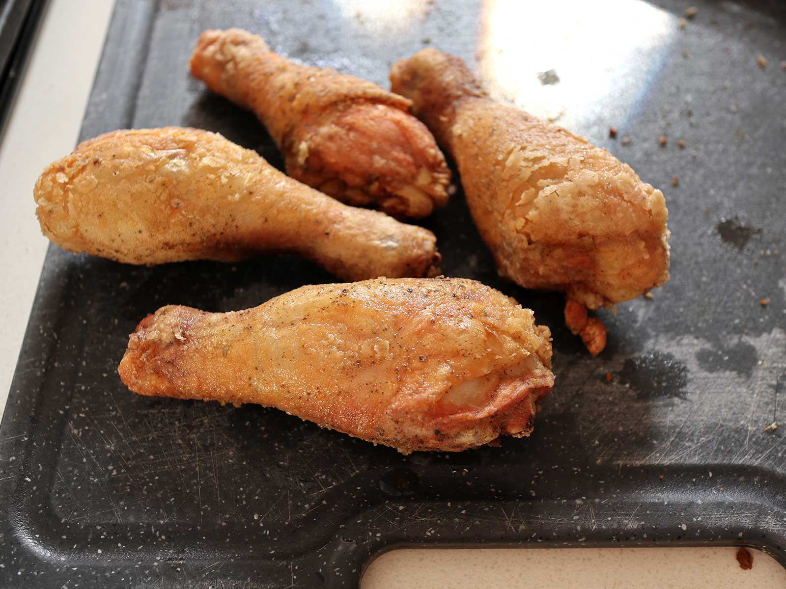 Fried chicken drumsticks after first frying
