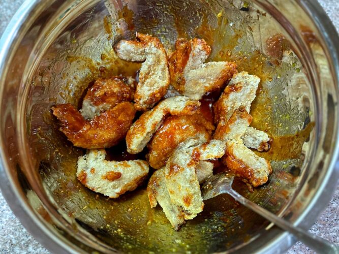 Glazing fried chicken wings with Korean sauce