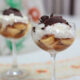 Banana slices, caramel, toasted coconut, whipped cream and shaved chocolate in glass