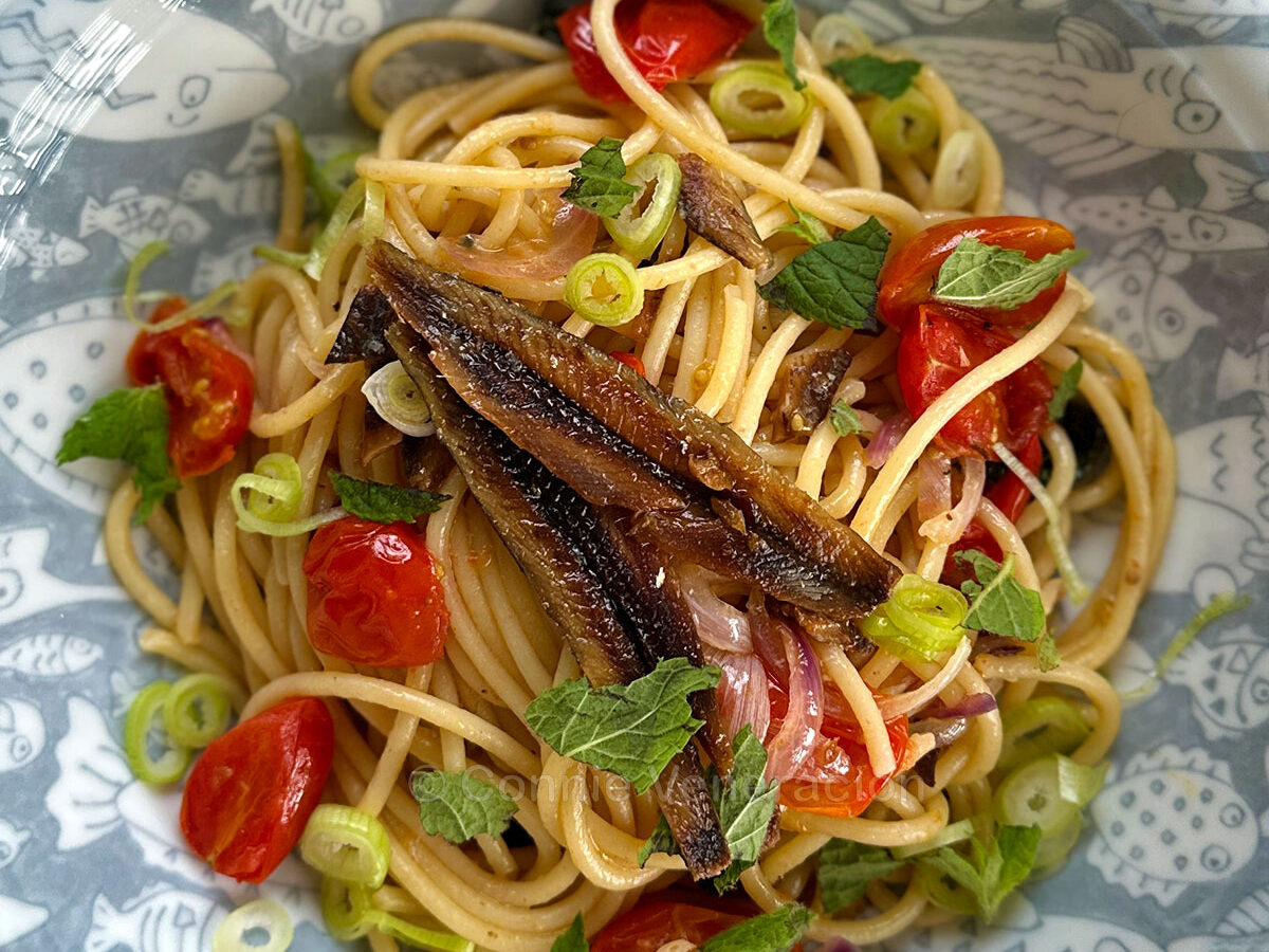 Spaghetti with gourmet tuyo, cherry tomatoes, Thai basil and mint