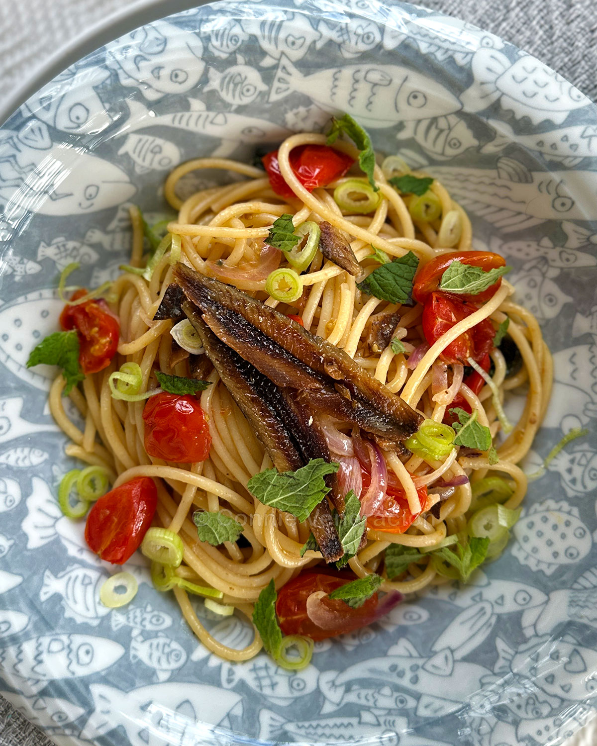 Spaghetti with gourmet tuyo, cherry tomatoes, Thai basil and mint