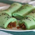 Pandan crepes with coconut and palm sugar filling (dadar gulong / kuih dadar)