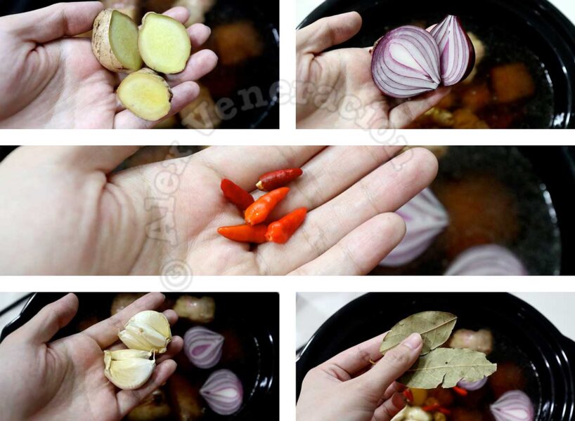 Adding ginger, shallots, chilies, garlic and bay leaves to beef in slow cooker