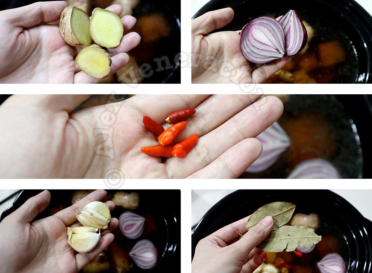 Adding ginger, shallots, chilies, garlic and bay leaves to beef in slow cooker