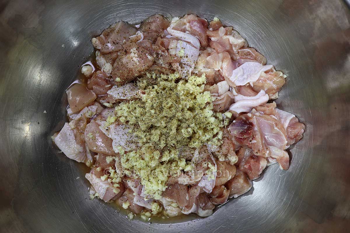 Chicken and garlic in mixing bowl