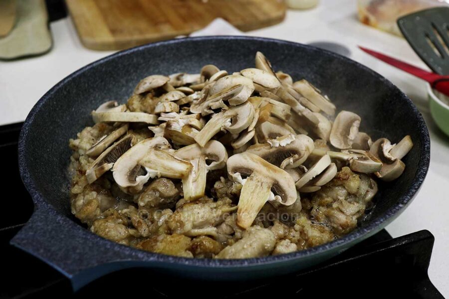 Mushrooms and browned chicken in pan