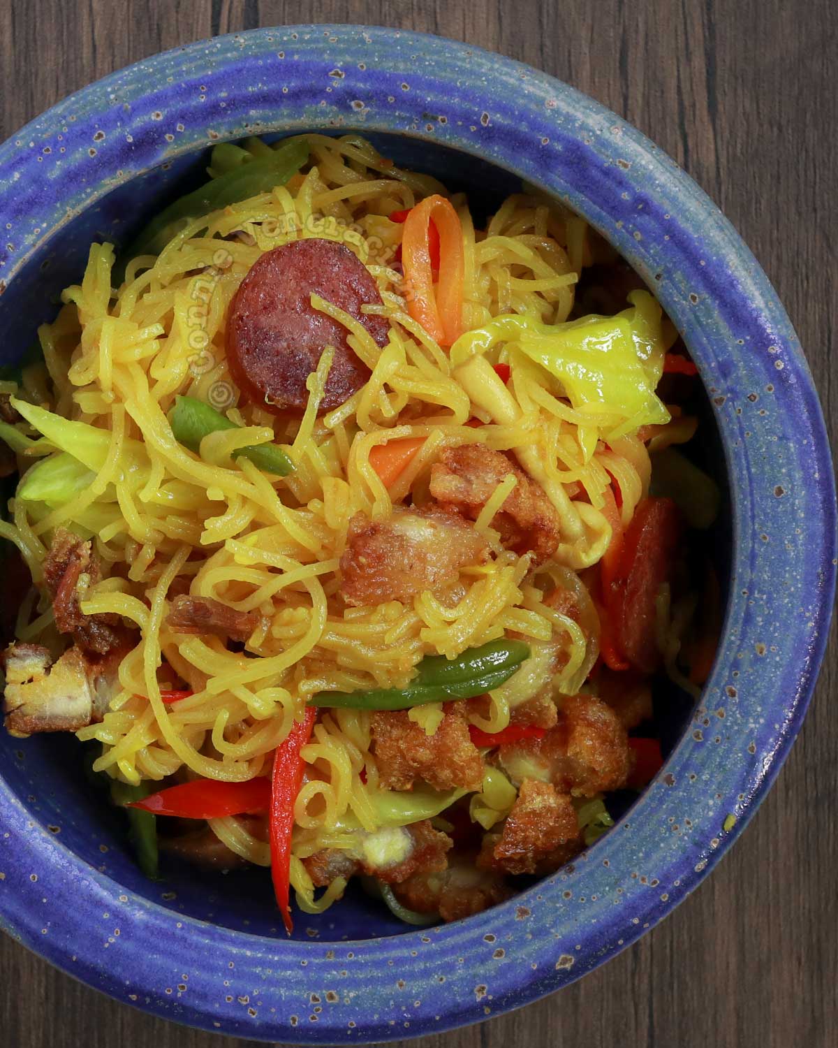 Singapore noodles (curry bee hoon) with crispy pork belly