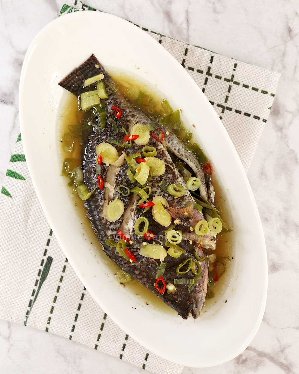 Steamed whole tilapia with ginger, chilies and scallions
