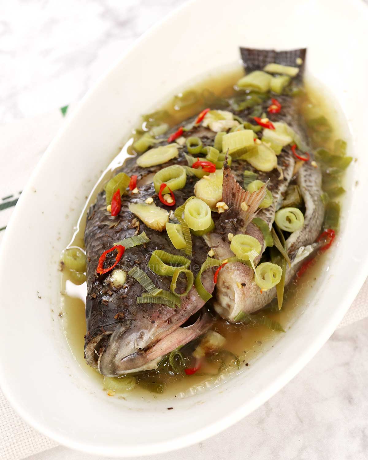 Steamed whole tilapia with ginger, chilies and scallions