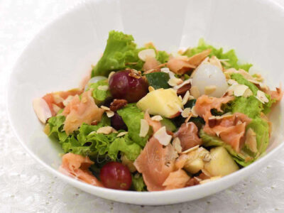 Smoked salmon salad with fruits and nuts