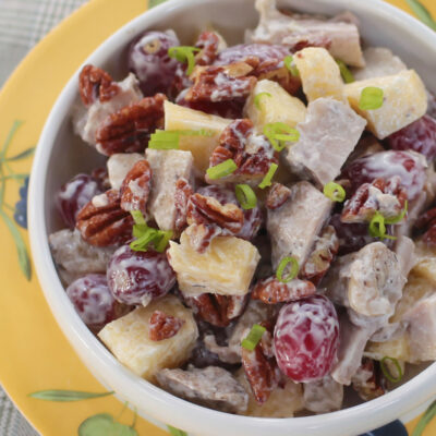Grilled chicken salad with fruits and nuts
